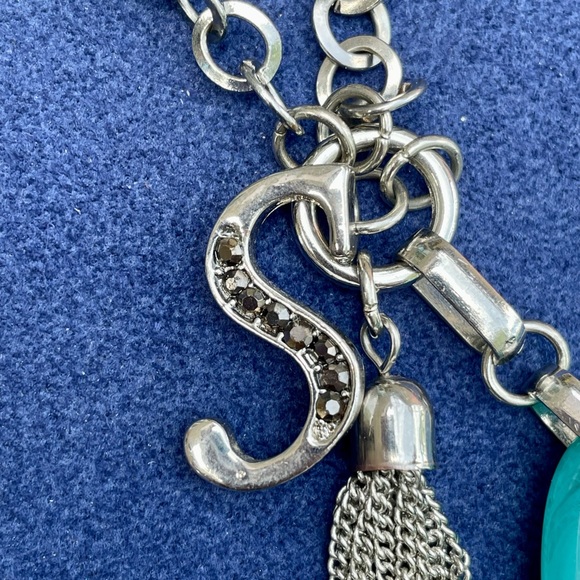 Silver colored necklace with large aqua colored stone, letter S & silver tassel - Picture 5 of 8